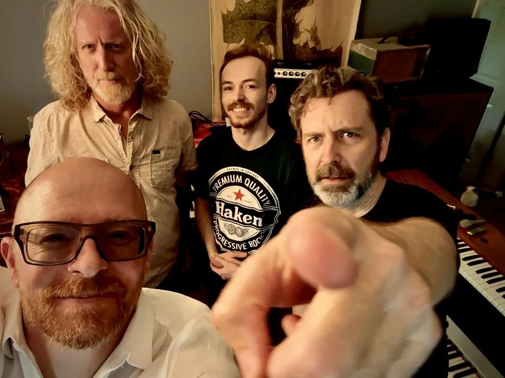 The four members of Mark Ross & The Contraptions gathered among vintage keyboards and amps.